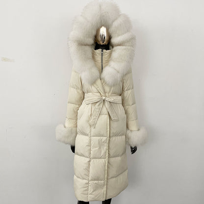 Long white puffer coat with large fur hood and cuffs on a mannequin against a light gray background