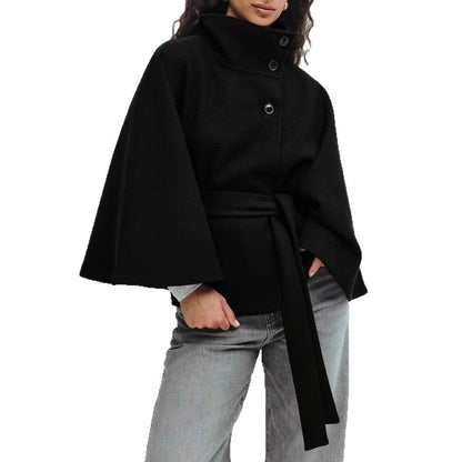 Black cape worn by a person on a white background