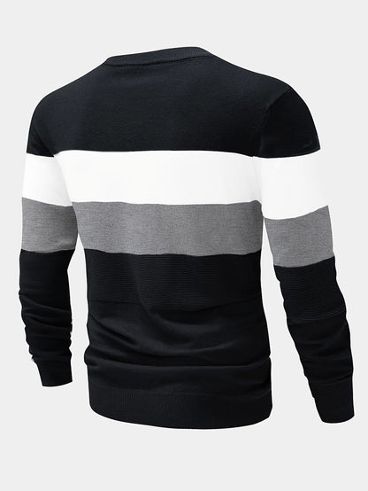 Black, white, and gray striped sweater on a light gray background