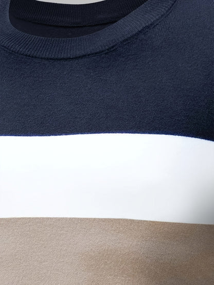 Close-up of a sweater with navy, white, and beige stripes.