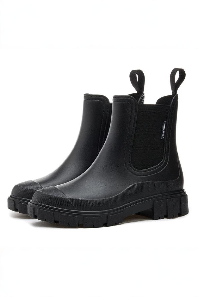Pair of black rubber boots on a white background