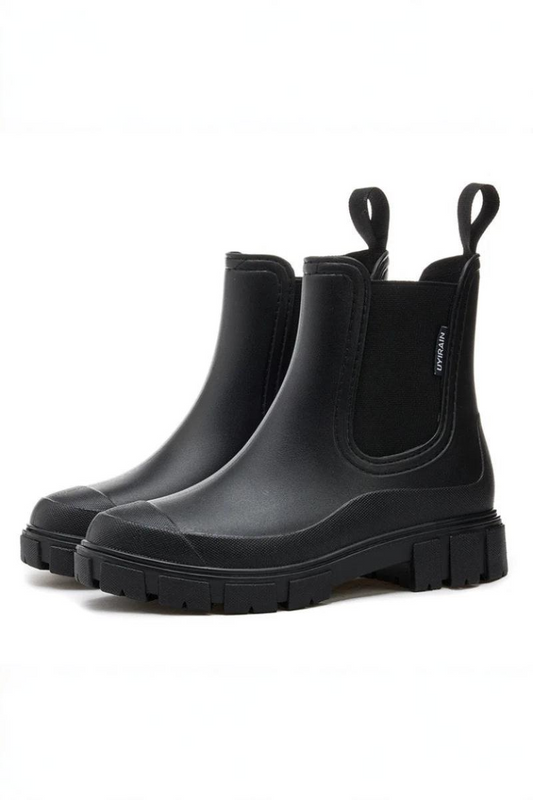 Pair of black rubber boots on a white background