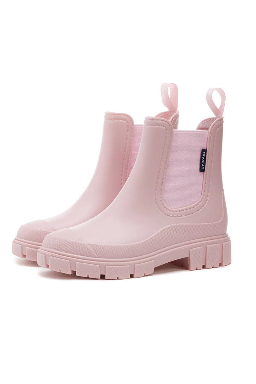 Pair of pink rain boots on a white background