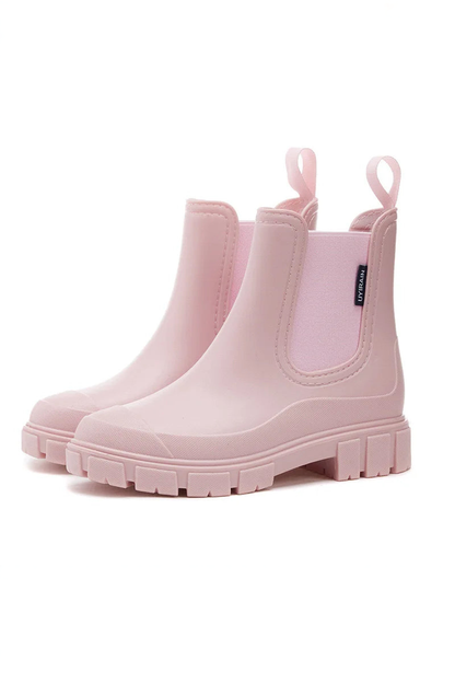 Pair of pink rain boots on a white background