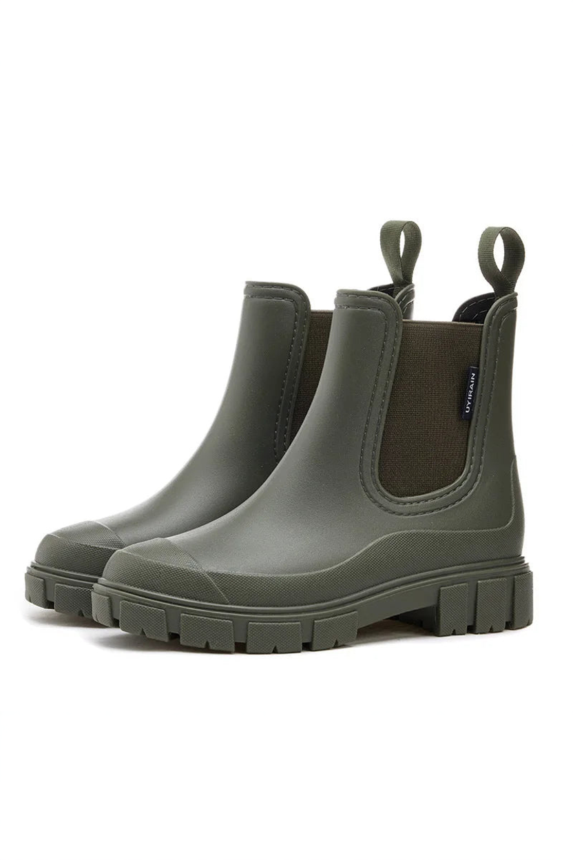 Pair of green rubber boots on a white background