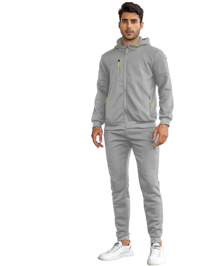 Man wearing a gray tracksuit with green accents on a white background