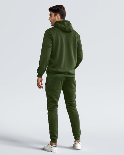 Man wearing a green tracksuit on a light gray background