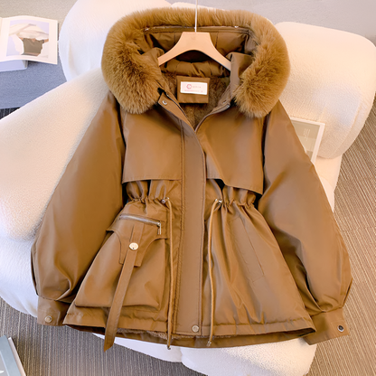Tan parka with fur hood on a white chair