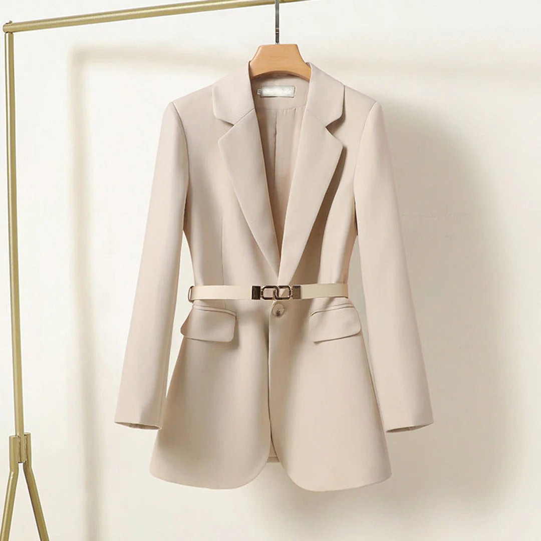 Beige blazer with a belt on a hanger against a white background