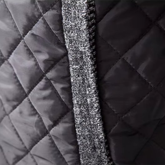 Close-up of quilted fabric with a textured stripe