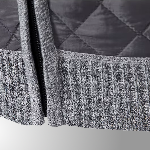 Close-up of a textured gray fabric with a zipper on a white background