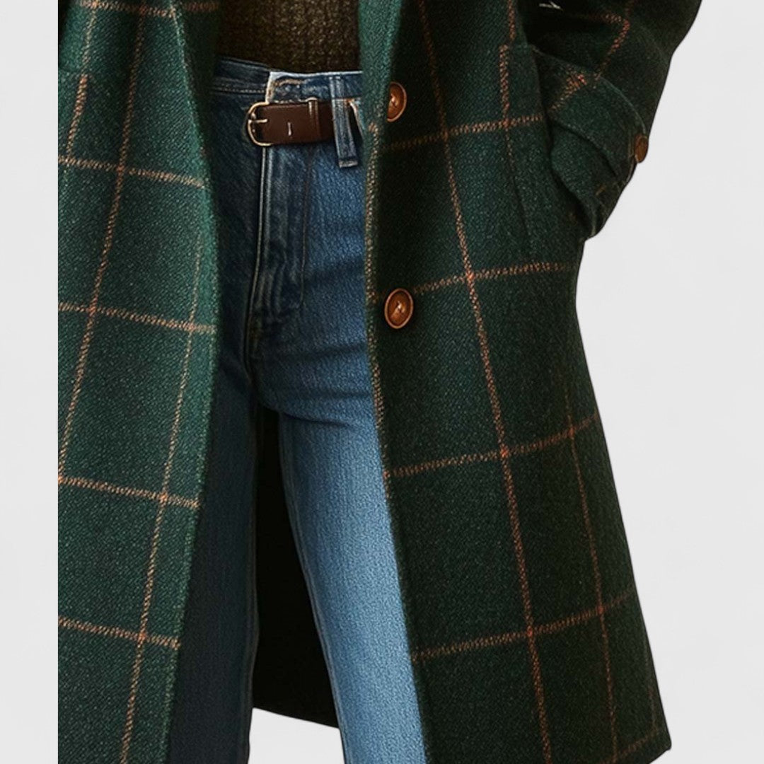 Green checkered coat with blue jeans on a light gray background