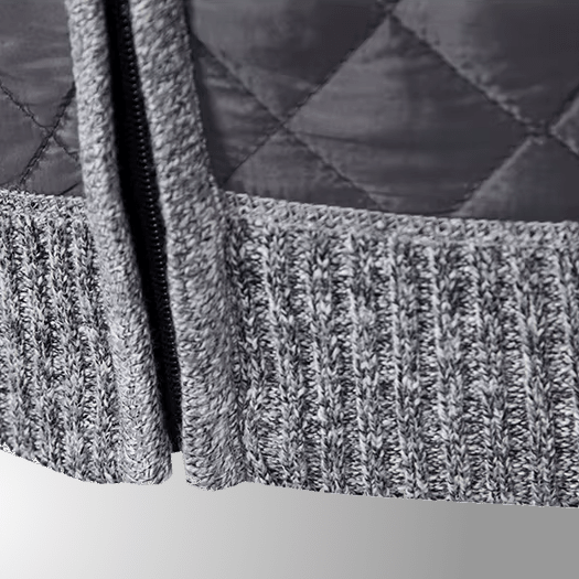 Close-up of a textured gray fabric with a zipper on a white background