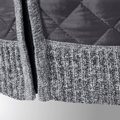 Close-up of a textured gray fabric with a zipper on a white background