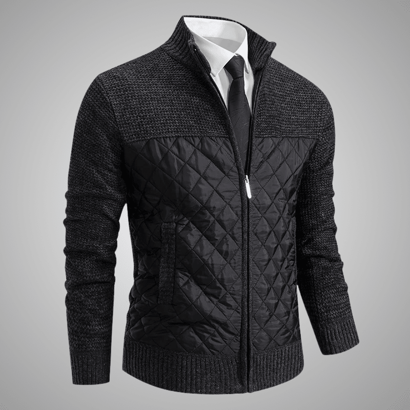 Black quilted jacket with a white shirt and tie on a gray background