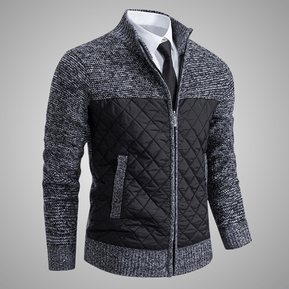 Gray and black quilted jacket on a gray background