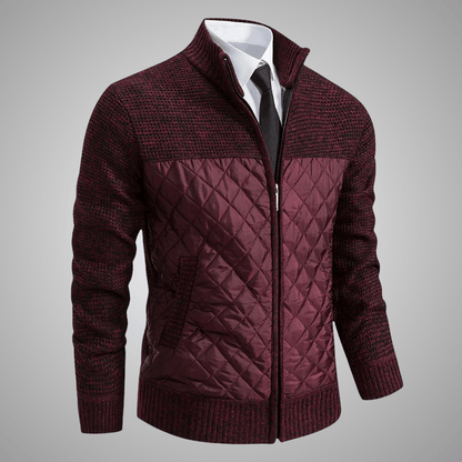 Maroon quilted jacket with a white shirt and black tie on a gray background
