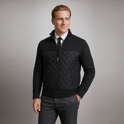 Man wearing a black quilted jacket on a gray background