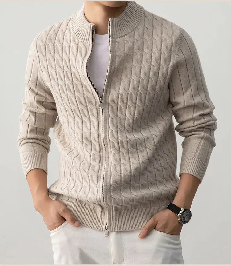 Beige cable knit sweater with a zipper on a plain background