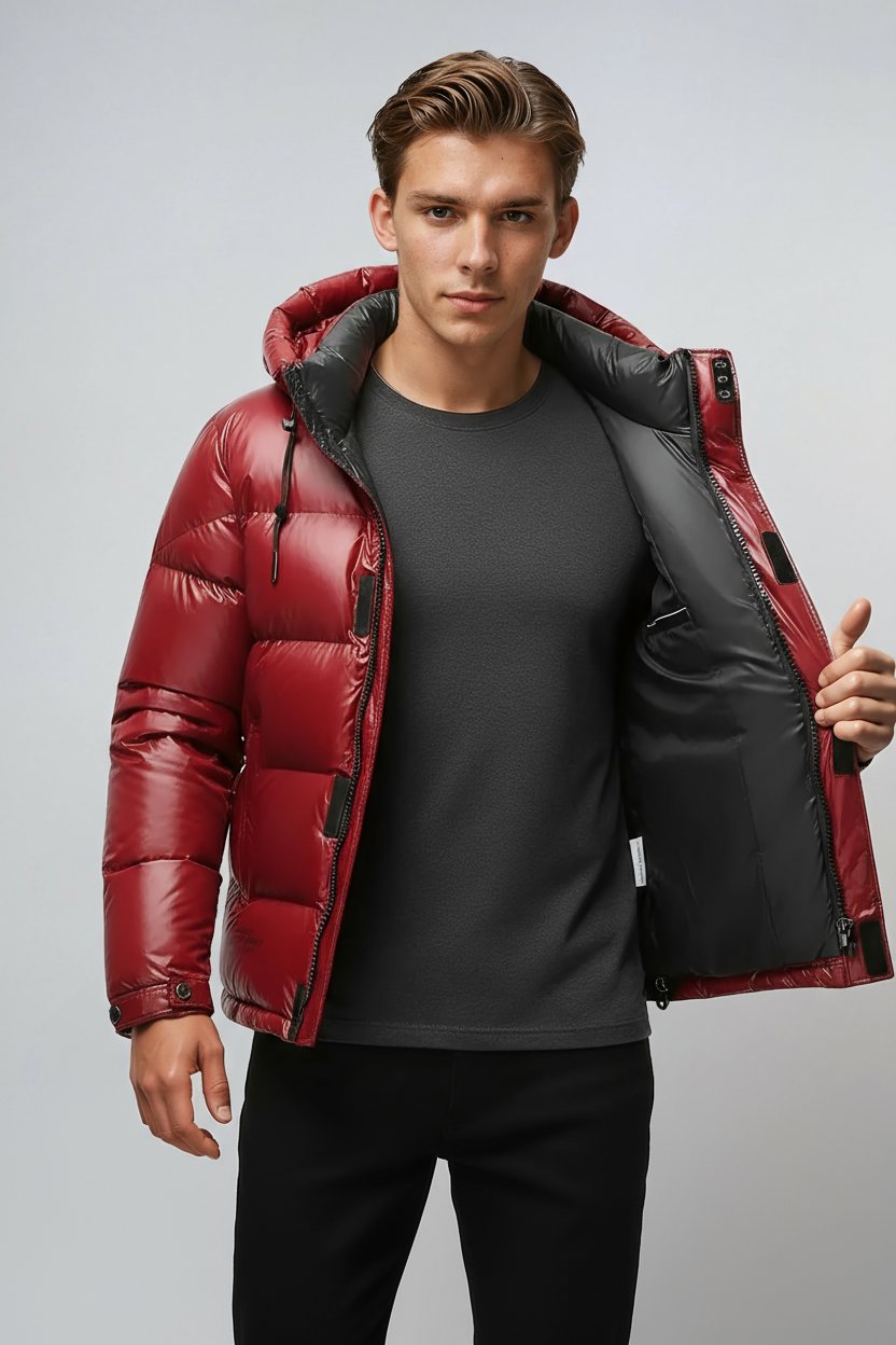 Man wearing a red puffer jacket with black interior on a gray background