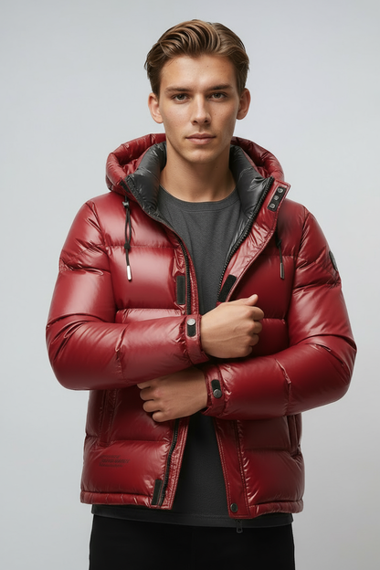 Man wearing a red puffer jacket against a light gray background