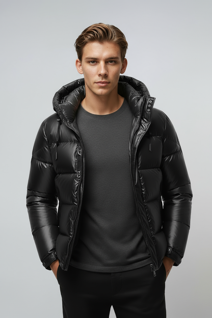 Man wearing a black puffer jacket on a light gray background