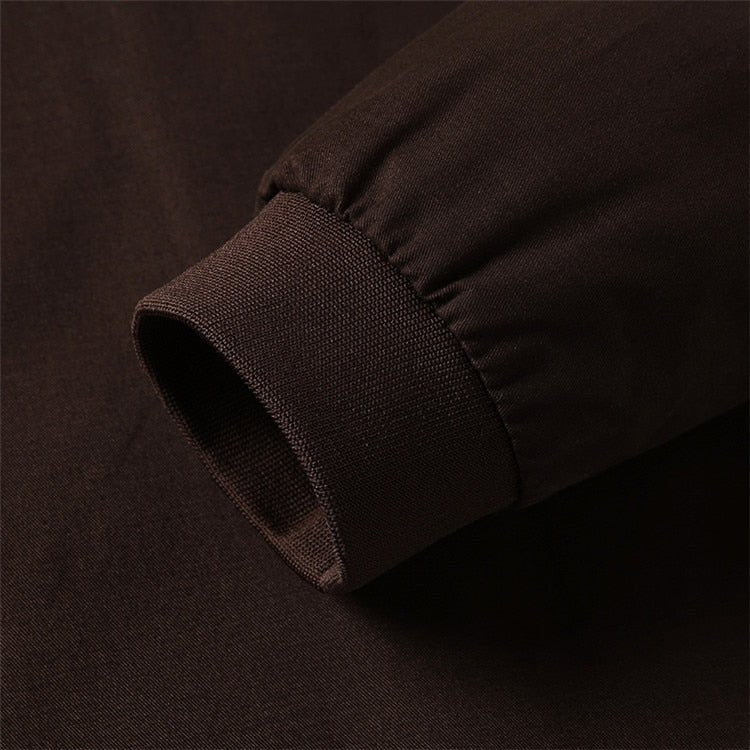 Close-up of a dark brown fabric texture on a matching background