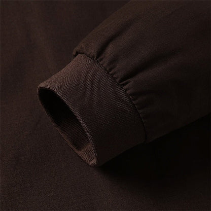 Close-up of a dark brown fabric texture on a matching background