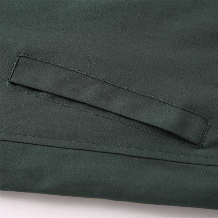 Close-up of a green fabric pocket on a garment.