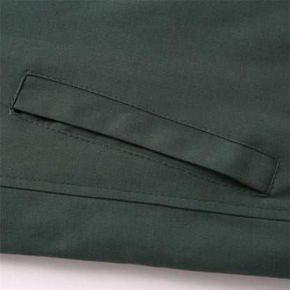 Close-up of a green fabric pocket on a garment.