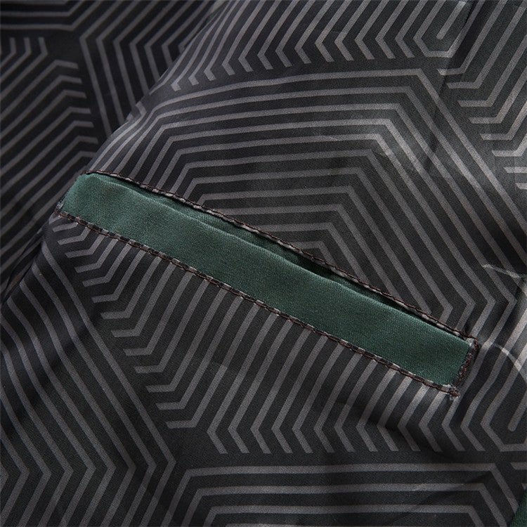 Close-up of a geometric patterned fabric with a green seam.