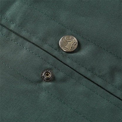 Close-up of a green fabric with buttons on a textured background