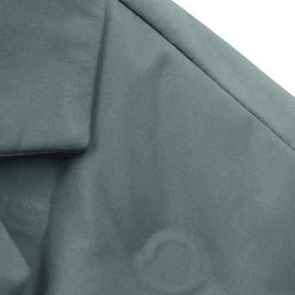 Close-up of textured green fabric with a brand logo.