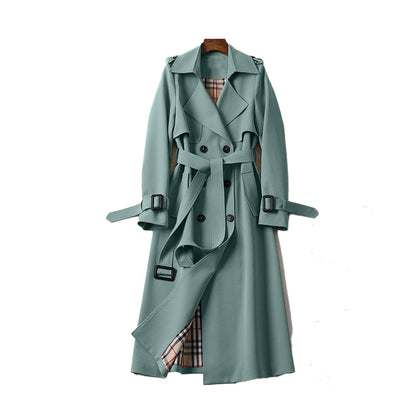Green trench coat with plaid lining on a white background