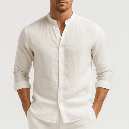 Man wearing a white linen shirt against a plain background