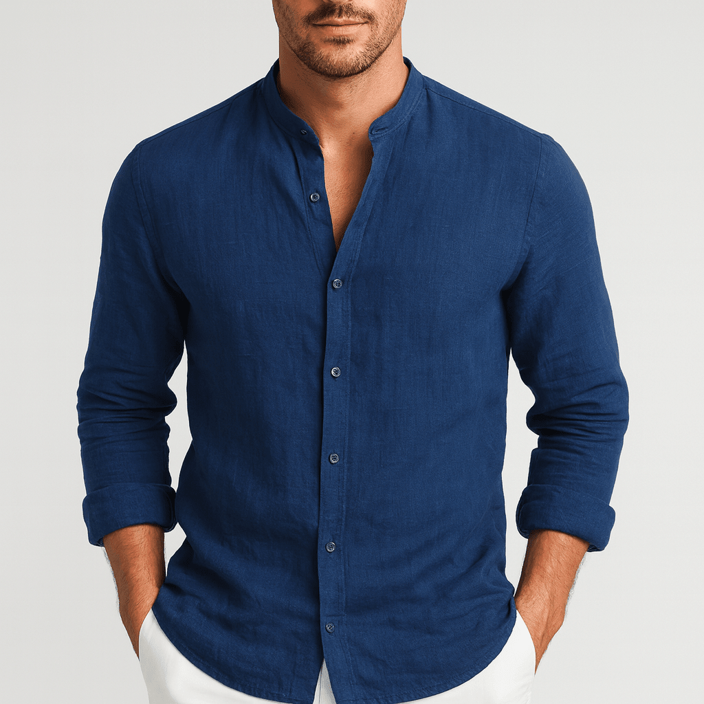 Man wearing a blue button-up shirt against a light gray background