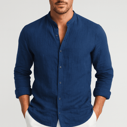 Man wearing a blue button-up shirt against a light gray background
