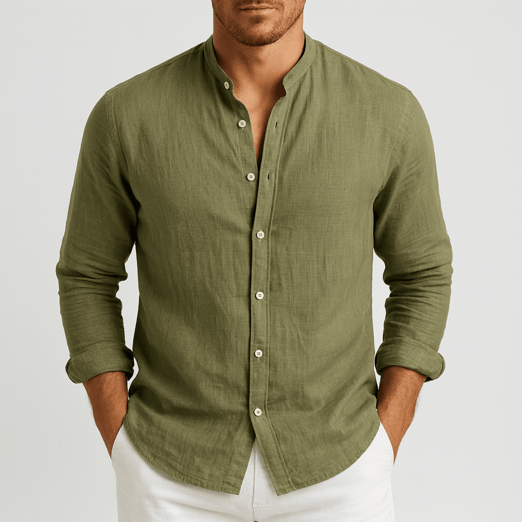 Man wearing a green button-up shirt with rolled-up sleeves on a light gray background