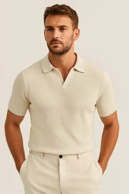 Man wearing a beige ribbed polo shirt and pants against a light background