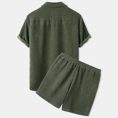 Green checkered shirt and shorts set on a light gray background