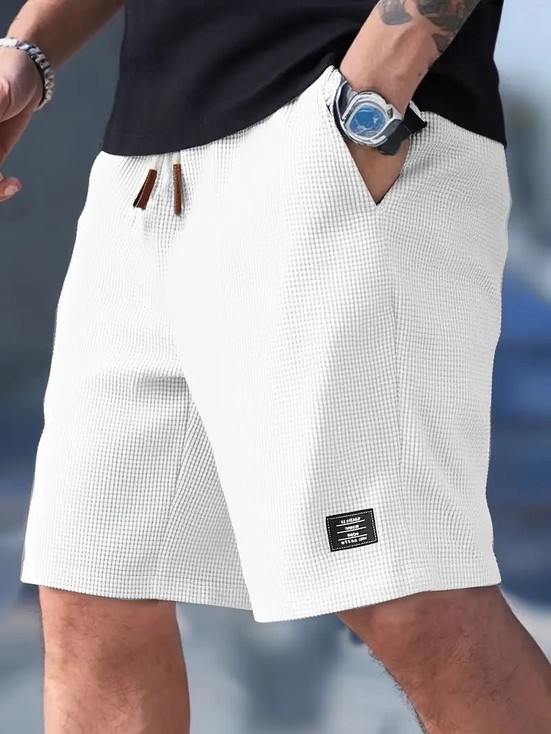 White checkered shorts worn by a person with a blurred background