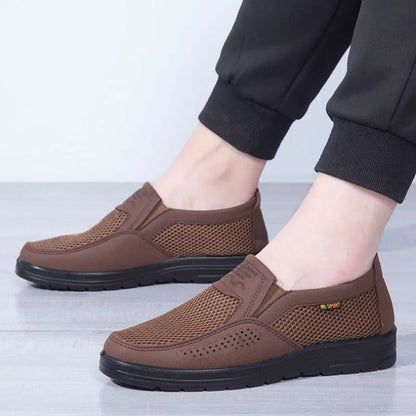 Brown shoes worn by a person on a light gray background