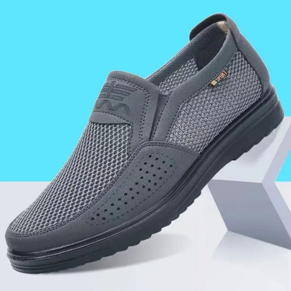 Gray slip-on shoe with mesh design on a blue and gray background