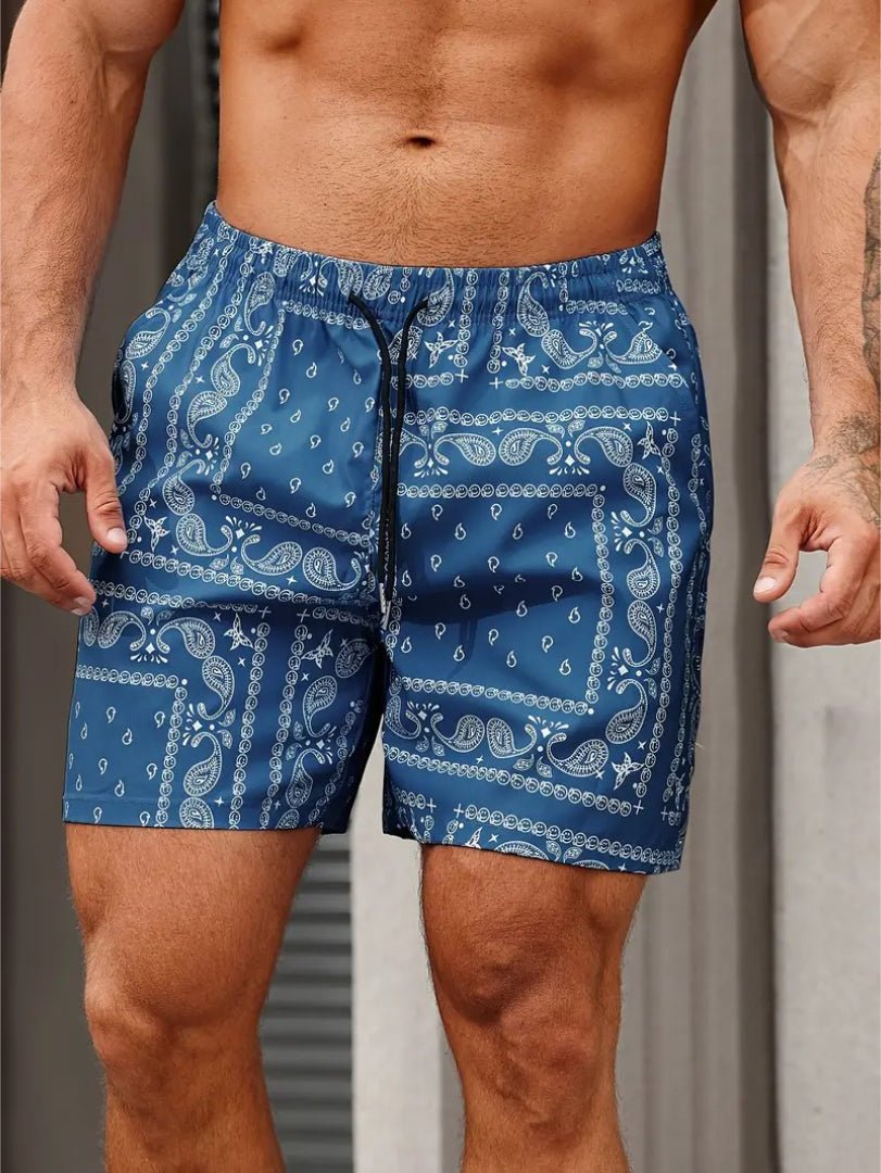 Blue patterned shorts worn by a person against a neutral background