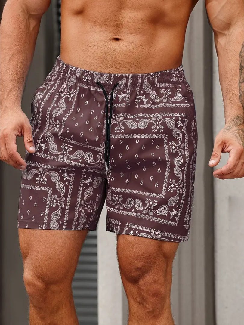 Man wearing maroon shorts with white paisley pattern against a neutral background