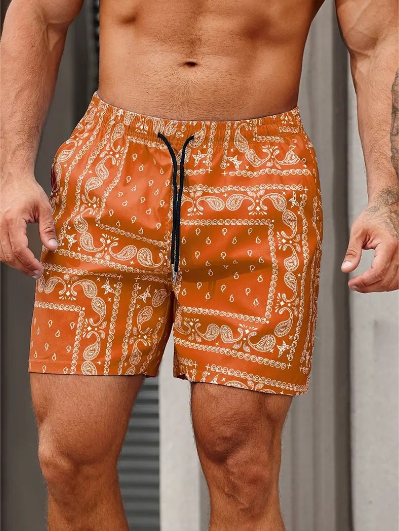 Orange patterned shorts worn by a person against a neutral background