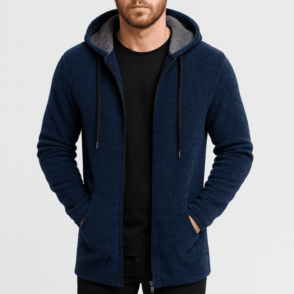 Man wearing a blue hoodie with gray lining on a light gray background