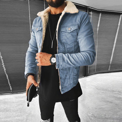 Person wearing a denim jacket with a shearling collar in an urban setting