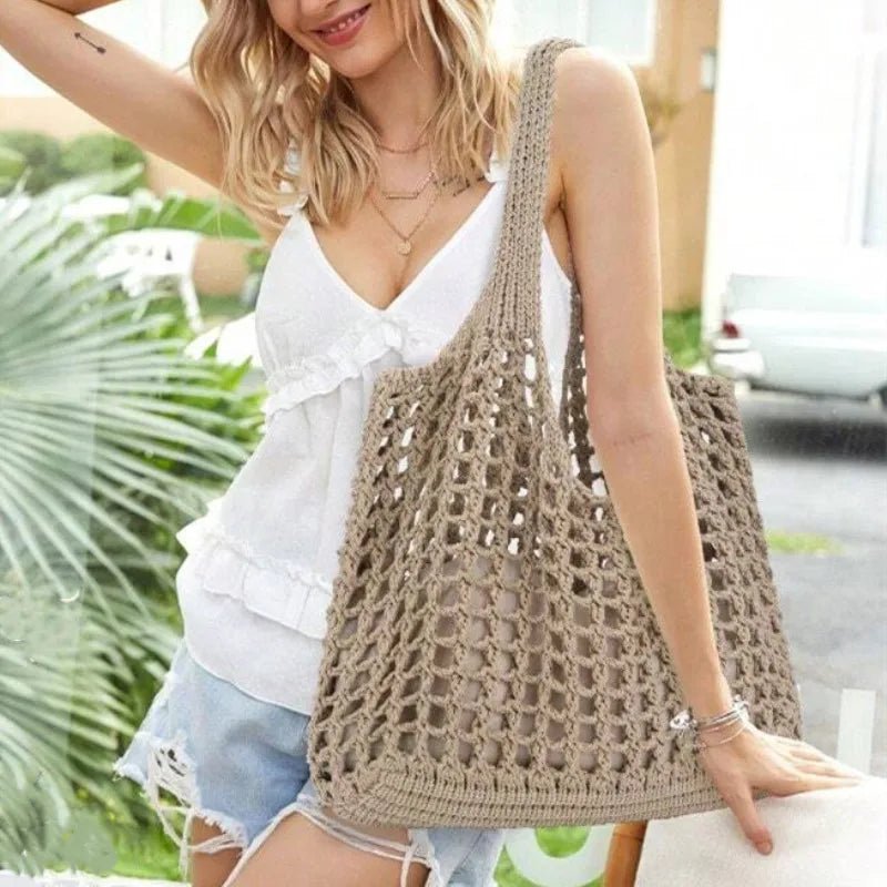Woman holding a beige crochet bag outdoors