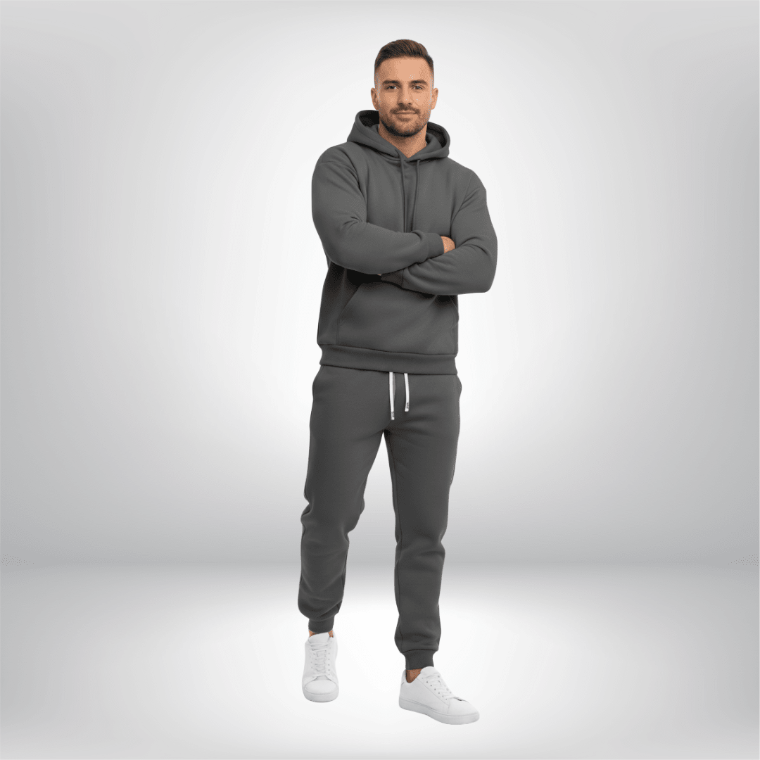 Man wearing a gray tracksuit on a light gray background